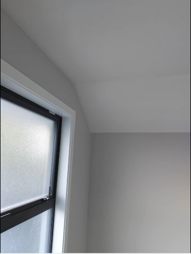 Cleanly painted window reveal and ceiling junction